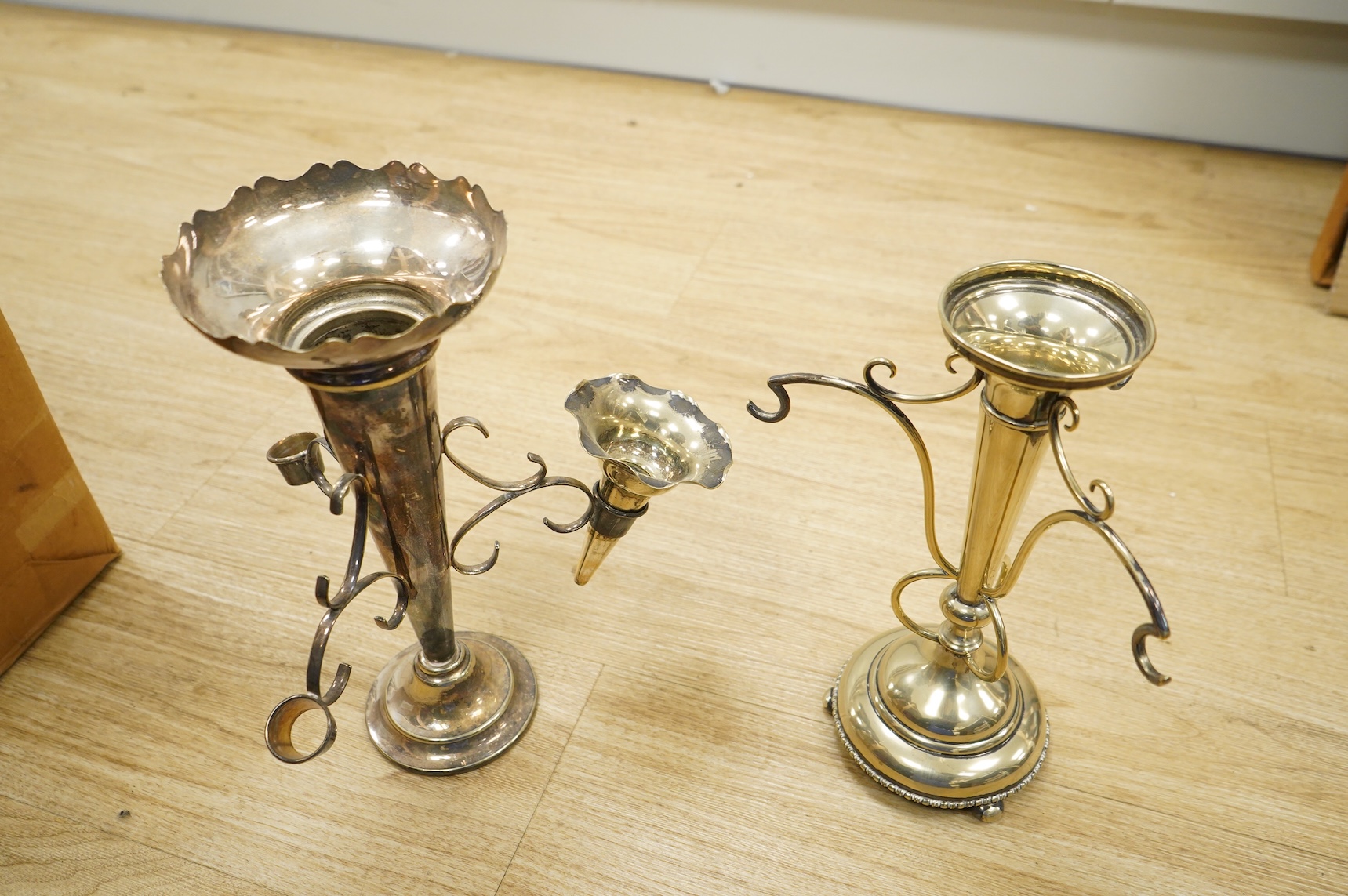 Three silver plated epergnes to include a naturalistic example decorated with leaves and vines